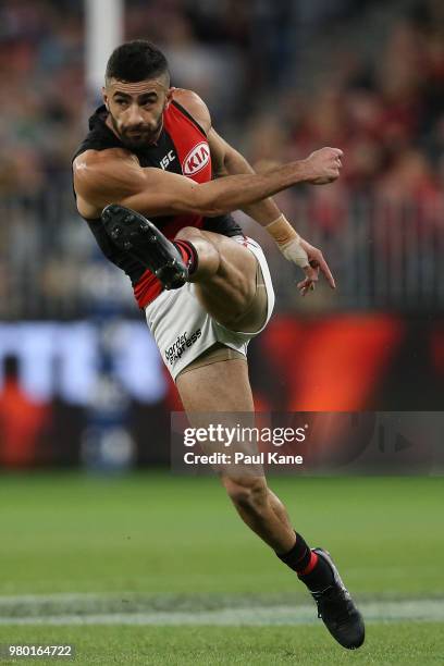 Adam Saad of the Bombers kicks the ball into the forward line during the round 14 AFL match between the West Coast Eagles and the Essendon Bombers at...