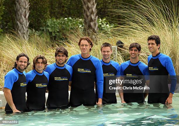 Fernando Gonzalez, David Ferrer, Eduardo Schwank, Dick Norman, Robin Soderling, Thomas Bellucci and Marcelo Melo pose with a dolphin during day two...
