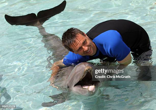 Robin Soderling poses with a dolphin during day two of the 2010 Sony Ericsson Open at Miami Seaquarium on March 24, 2010 in Key Biscayne, Florida.