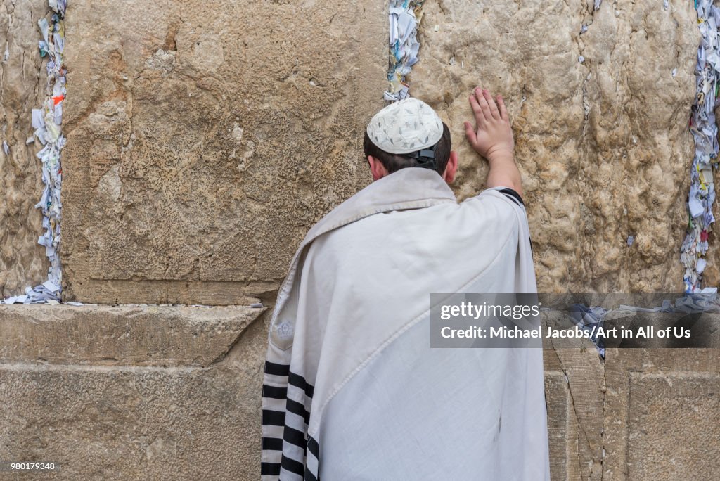 Orthodox jewish man praying at the wailing wall - kotel in Jerusalem, Israel