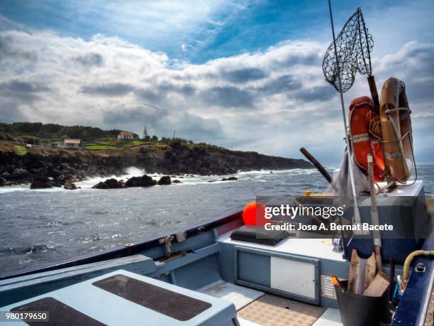 ship of traditional fishing out of the water in a fishing port maritime in terceira island in the azores islands, portugal. - barco pesquero fotografías e imágenes de stock