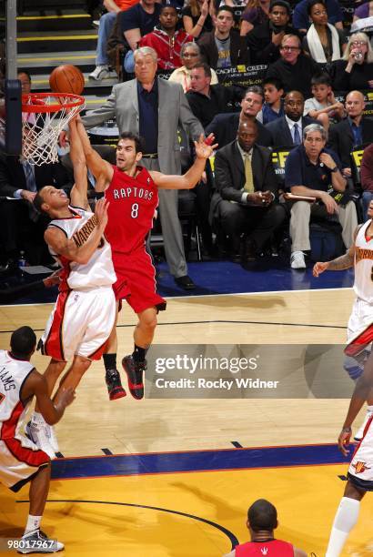 Jose Calderon of the Toronto Raptors shoots a layup against Stephen Curry of the Golden State Warriors during the game at Oracle Arena on March 13,...