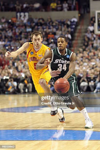 Korie Lucious of the Michigan State Spartans drives the ball against Eric Hayes of the Maryland Terrapins during the second round of the 2010 NCAA...