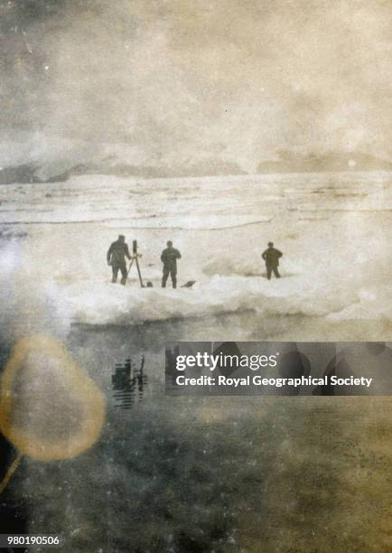 Expedition members taking photographs, Image taken from an album donated to the Society by Aubrey Ninnis, a member of the Ross Sea Party, Antarctica,...