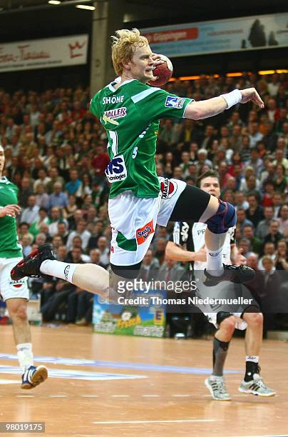 Christian Schoene of Goeppingen jumps with the ball during the Handball Bundesliga match between Frisch Auf Goeppingen and THW Kiel at the EWS Arena...
