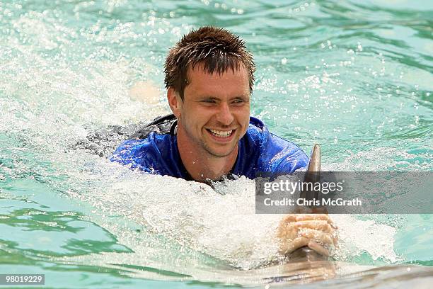 Robin Soderling swims with a dolphin during day two of the 2010 Sony Ericsson Open at Miami Seaquarium on March 24, 2010 in Key Biscayne, Florida.