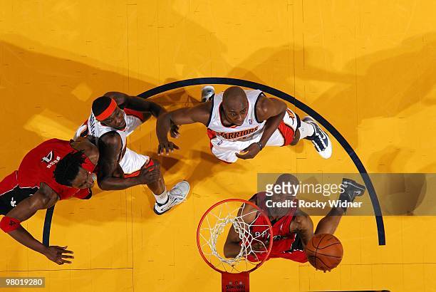 Jarrett Jack of the Toronto Raptors shoots a layup against Anthony Tolliver and Anthony Morrow of the Golden State Warriors during the game at Oracle...