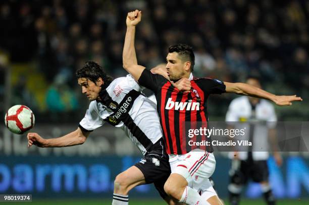 Massimo Paci of Parma FC competes for the ball with Marco Borriello of AC Milan during the Serie A match between Parma FC and AC Milan at Stadio...