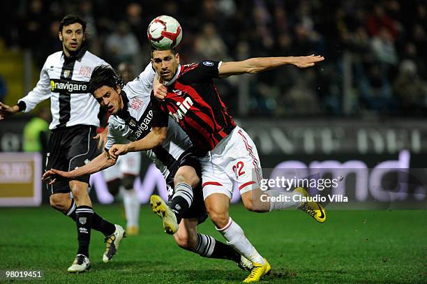 Massimo Paci of Parma FC competes for the ball with Marco Borriello of AC Milan during the Serie A match between Parma FC and AC Milan at Stadio...