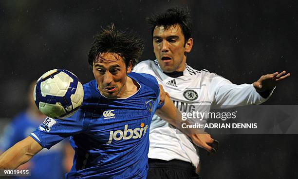 Portsmouth's English forward Tommy Smith vies with Chelsea's Portuguese defender Paulo Ferreira during the English Premier League football match...