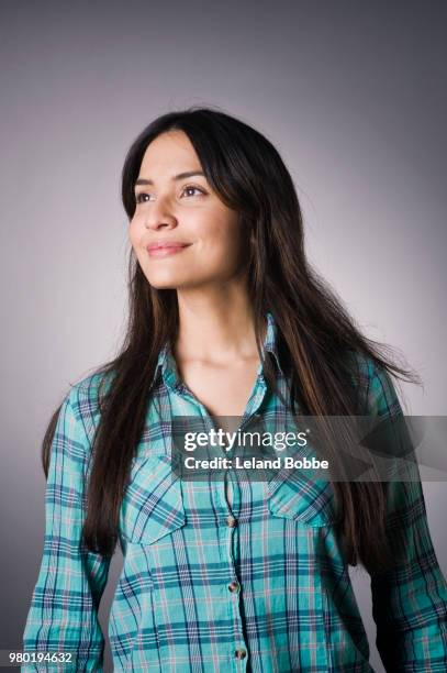 studio portraits of hispanic woman with long dark hair - plaid shirt stock-fotos und bilder