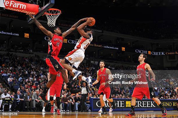 Reggie Williams of the Golden State Warriors goes up for a shot against Amir Johnson of the Toronto Raptors during the game at Oracle Arena on March...