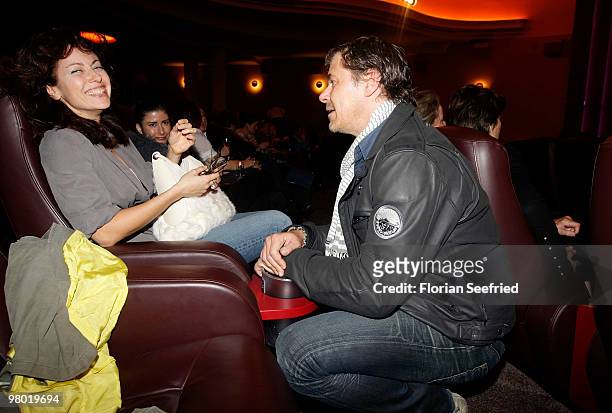 Actress Carolina Vera Squella and actor Sven Martinek laugh while attening the premiere of 'Haltet Die Welt an' at cinema Astor Film Lounge on March...