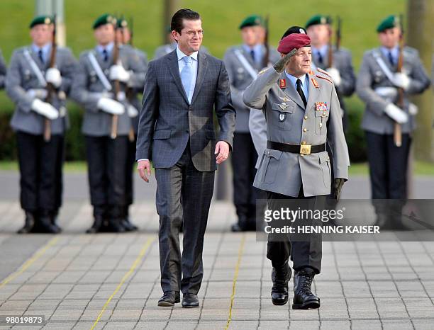 German Defence Minister Karl-Theodor zu Guttenberg and Chief of German Army Lt. Gen. And parting army inspector Hans Otto Budde walk past the...