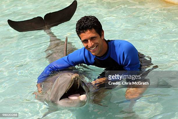 Marcelo Melo poses with a dolphin during day two of the 2010 Sony Ericsson Open at Miami Seaquarium on March 24, 2010 in Key Biscayne, Florida.