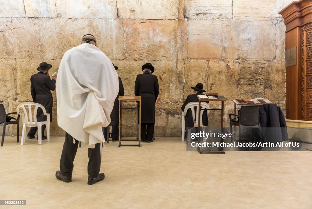 Orthodox jewish men praying at the wailing wall - kotel in Jerusalem, Israel