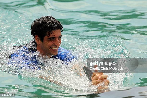 Thomas Bellucci swims with a dolphin during day two of the 2010 Sony Ericsson Open at Miami Seaquarium on March 24, 2010 in Key Biscayne, Florida.