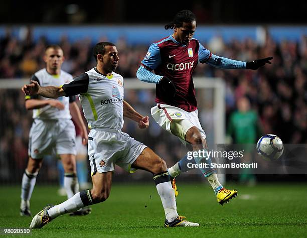 Nathan Delfounesco of Aston Villa is challenged by Anton Ferdinand of Sunderland during the Barclays Premiership League match between Aston Villa and...