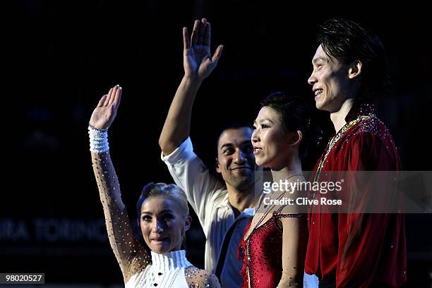 Qing Pang and Jian Tong of China look on as Aliona Savchenko and Robin Szolkowy of Germany wave to the crowd after the Pairs Free Skate during the...