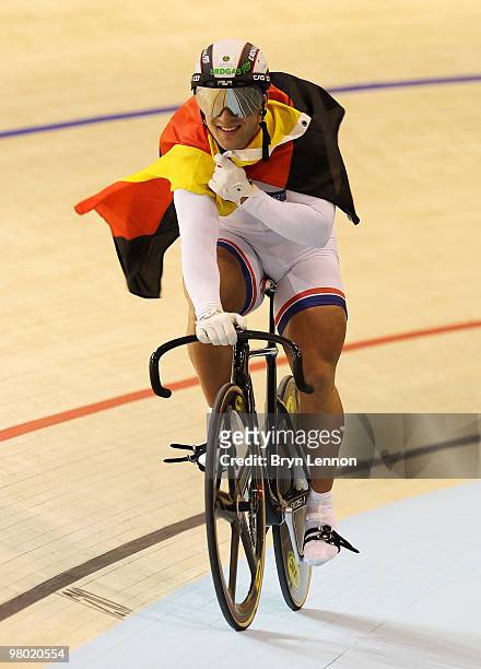 Robert Forstemann of Germany carries the Germany flag after winning Men's Team Sprint on Day One of the UCI Track Cycling World Championships at the...
