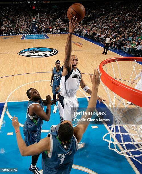 Shawn Marion of the Dallas Mavericks shoots over Al Jefferson and Ryan Hollins of the Minnesota Timberwolves during the game at the American Airlines...