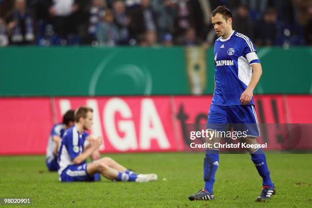 Ivan Rakitic and Heiko Westermann of Schalke look dejected after losing 0-1 after extra time the DFB Cup semi final match between FC Schalke 04 and...