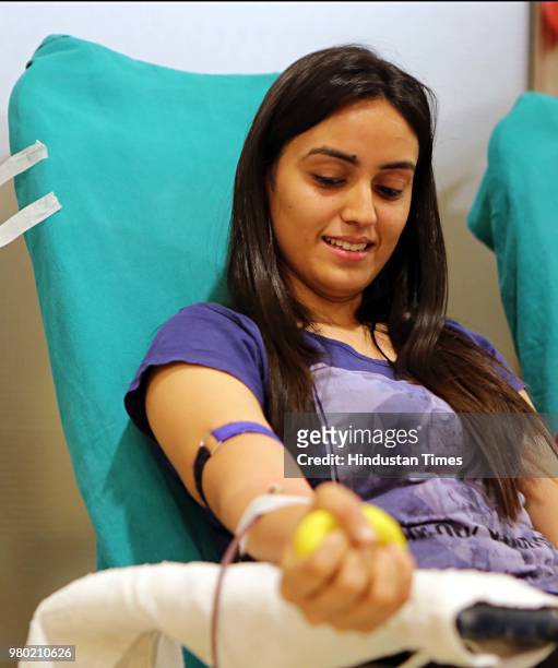 Girl donates blood during a blood donation camp organised by Aarone Group along with Select Citywalk, one of the most popular shopping malls in...