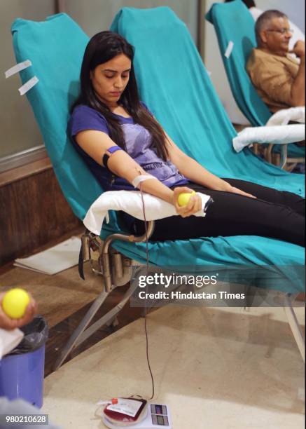 Girl donates blood during a blood donation camp organised by Aarone Group along with Select Citywalk, one of the most popular shopping malls in...