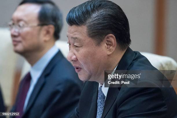 China's President Xi Jinping listens Papua New Guinea Prime Minister Peter O'Neill during a meeting at the Diaoyutai State Guesthouse on June 21...