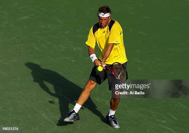 David Nalbandian of Argentina returns a shot against Lukasz Kubot of Poland during day two of the 2010 Sony Ericsson Open at Crandon Park Tennis...