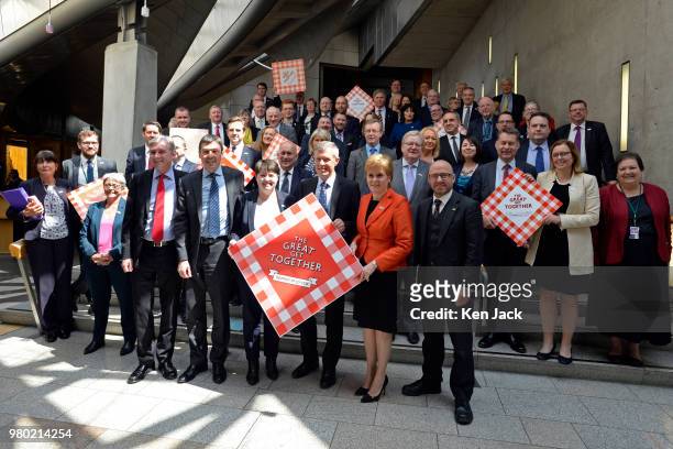 Scotland's First Minister Nicola Sturgeon together with other party leaders and MSPs of all parties take part in a photocall in the Garden Lobby of...