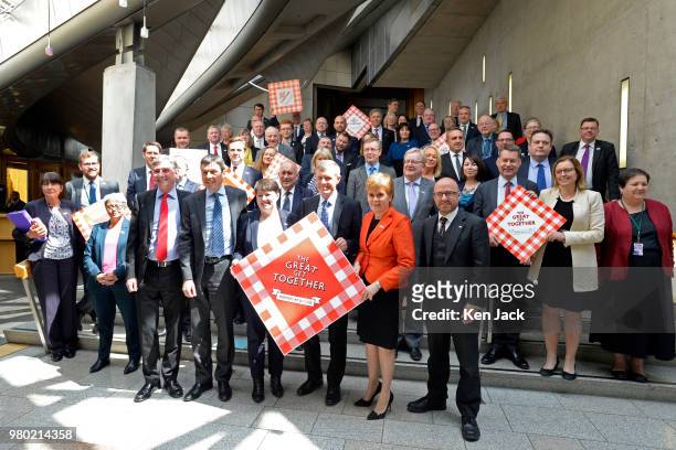 Scotland's First Minister Nicola Sturgeon together with other party leaders and MSPs of all parties take part in a photocall in the Garden Lobby of...