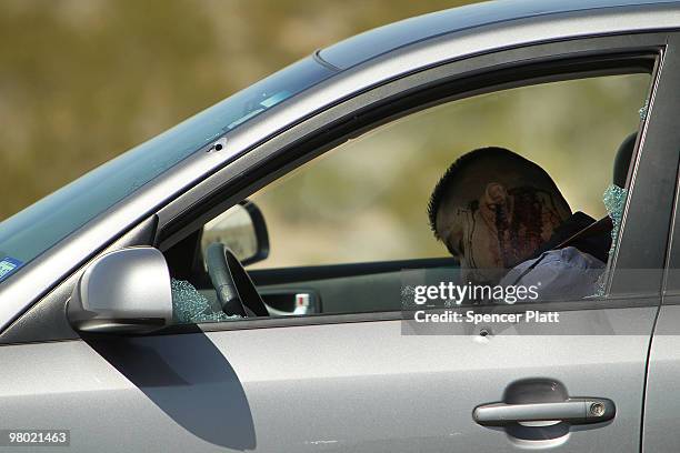 Bullet-ridden body lies in a car bearing Texas license plates on March 24, 2010 in Juarez, Mexico. Secretary of State Hillary Rodham Clinton, Defense...