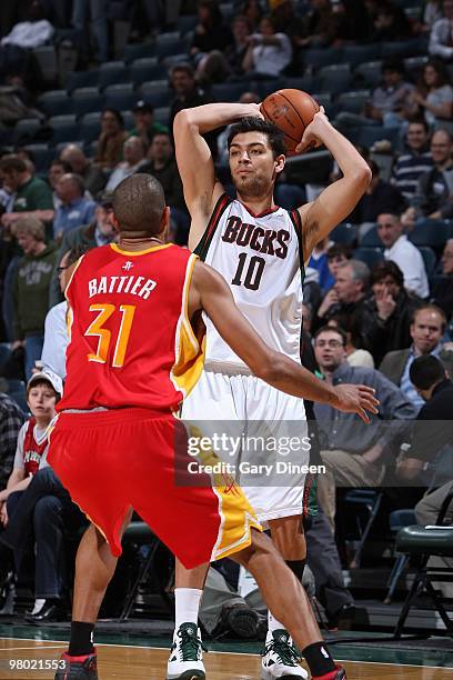 Carlos Delfino of the Milwaukee Bucks moves the ball against Shane Battier of the Houston Rockets during the game on February 17, 2010 at the Bradley...