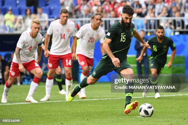 Australia's midfielder Mile Jedinak scores from the penalty spot for Australia's first goal to equalise 1-1 during the Russia 2018 World Cup Group C...