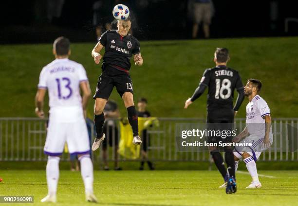 Orlando City defender Mohamed El-Munir watches a clearance by D.C. United defender Frederic Brillant during a USOC round of sixteen match between D.C...