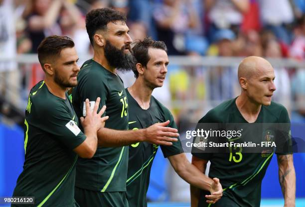 Mile Jedinak of Australia celebrates with team mates Aaron Mooy, Robbie Kruse and Joshua Risdon after scoring his team's first goal during the 2018...