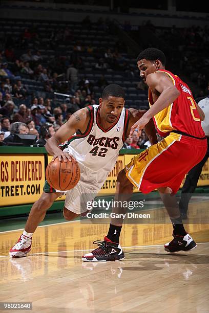 Charlie Bell of the Milwaukee Bucks moves the ball against Garrett Temple of the Houston Rockets during the game on February 17, 2010 at the Bradley...