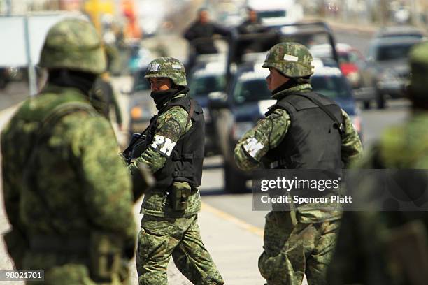 Members of the Mexican military police keep guard at the scene of the murder of two women aged 17 and 21 March 24, 2010 in Juarez, Mexico. Secretary...