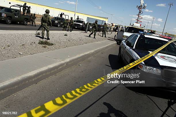 Military police keep guard at the site of a murder on March 24, 2010 in Juarez, Mexico. Secretary of State Hillary Rodham Clinton, Defense Secretary...