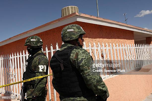Members of the Mexican military police keep guard at the scene of the murder of two women aged 17 and 21 March 24, 2010 in Juarez, Mexico. Secretary...