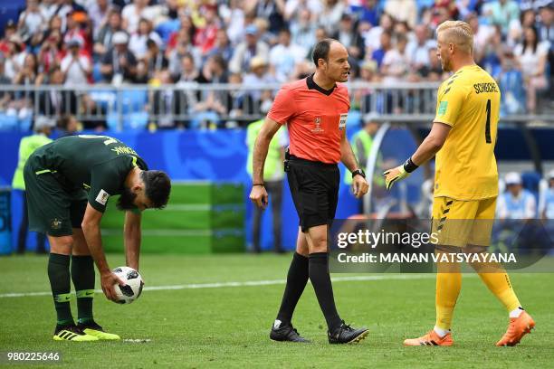 Denmark's goalkeeper Kasper Schmeichel talks with Spanish referee Antonio Mateu Lahoz as Australia's midfielder Mile Jedinak prepares to take a...