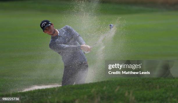 Thomas Pieters of Belgium plays out of a bunker on the 1st hole during day one of the BMW International Open at Golf Club Gut Larchenhof on June 21,...