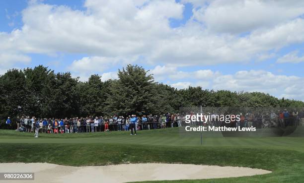 Tommy Fleetwood of England chips onto the 2nd green during day one of the BMW International Open at Golf Club Gut Larchenhof on June 21, 2018 in...