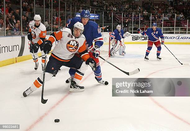 Matt Moulson of the New York Islanders takes the puck in front of Marc Staal of the New York Rangers at Madison Square Garden on March 24, 2010 in...