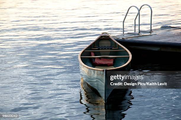 canoe at a dock, lake of the woods, ontario, canada - lake of the woods stock pictures, royalty-free photos & images