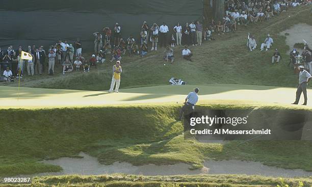 Justin Leonard chips from a front bunker near the 18th green during the final round at Whistling Straits, site of the 86th PGA Championship in Haven,...