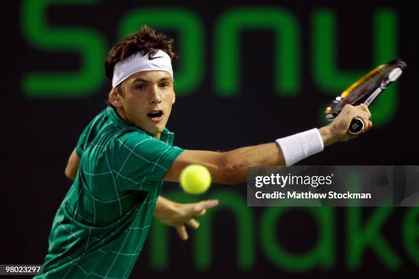 Filip Krajinovic of Serbia returns a shot against James Blake of the United States during day two of the 2010 Sony Ericsson Open at Crandon Park...