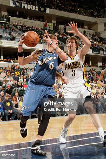 Mike Miller of the Washington Wizards drives on Troy Murphy of the Indiana Pacers at Conseco Fieldhouse on March 24, 2010 in Indianapolis, Indiana....