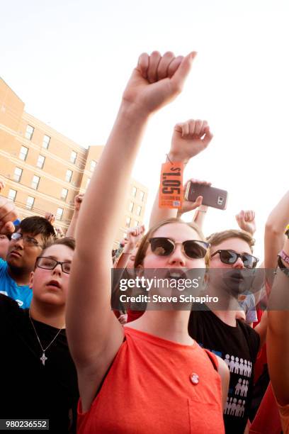 Low-angle view of young people as they raise their hands during in the annual End of the School Year Peace March & Rally in the South Side...